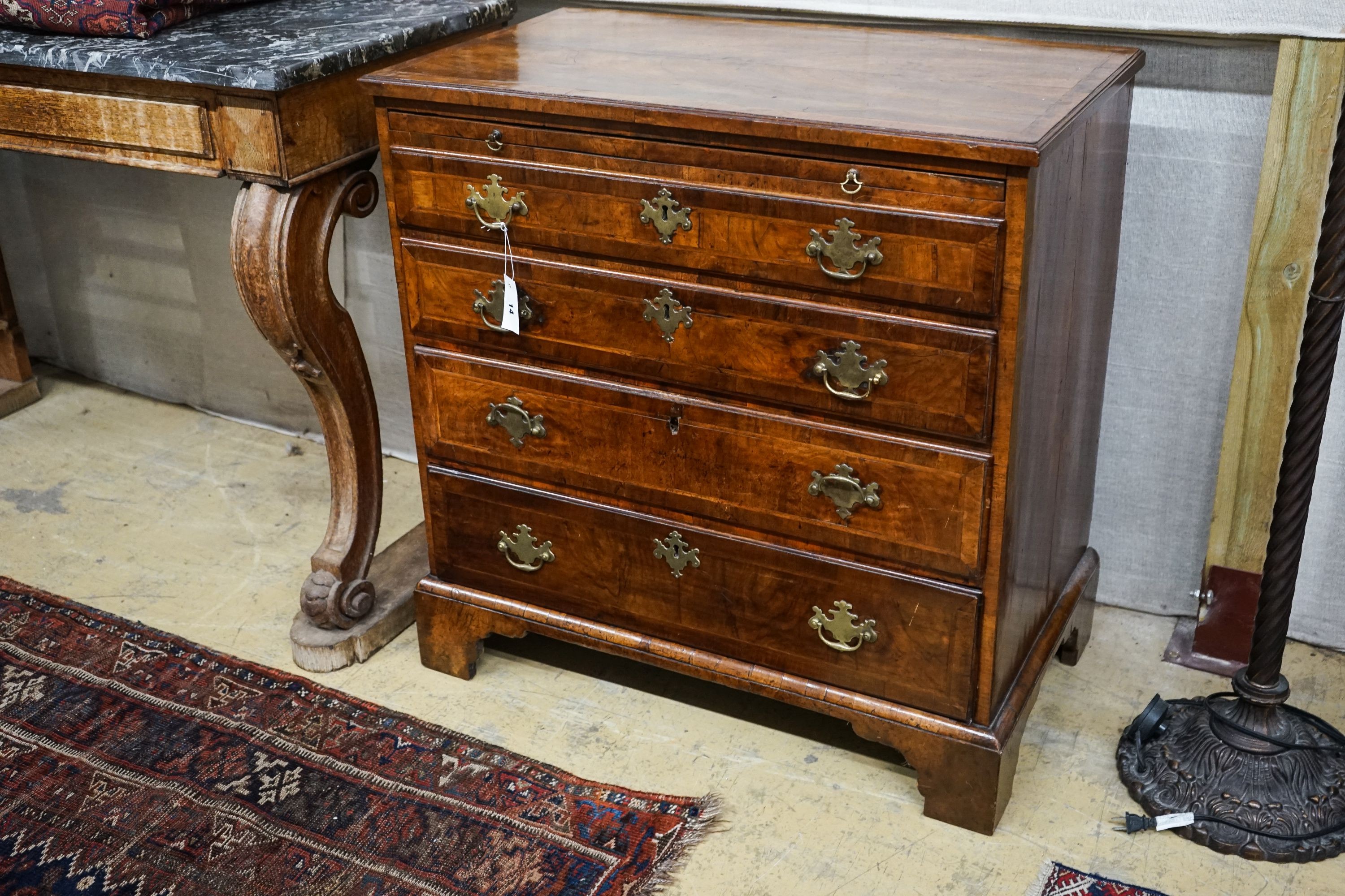 An 18th century and later feather banded walnut chest with slide, width 84cm, depth 49cm, height 86cm